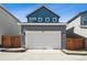 A two car garage and partial view of the house at 3360 N Coolidge Way Way, Aurora, CO 80019