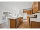 Bright kitchen features stainless appliances, light wood cabinets and an island with a sink at 3360 N Coolidge Way Way, Aurora, CO 80019