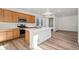 Bright kitchen featuring an island with stainless steel appliances, hardwood flooring and modern finishes at 3360 N Coolidge Way Way, Aurora, CO 80019