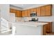 Bright kitchen features stainless appliances, a kitchen island and modern cabinets at 3360 N Coolidge Way Way, Aurora, CO 80019