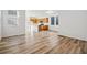 Open-concept living space with beautiful hardwood flooring, natural light and views into the kitchen at 3360 N Coolidge Way Way, Aurora, CO 80019