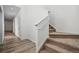 Hallway view showcases staircase with carpeted steps and white railing and open doorway at 3360 N Coolidge Way Way, Aurora, CO 80019