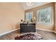 Bright bedroom with warm paint, wood floors, and lots of natural light from the oversized windows at 13704 E Lehigh Ave # D, Aurora, CO 80014