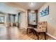 Cozy dining area with seating for four, a painting, and seamless access to the entryway and living room at 13704 E Lehigh Ave # D, Aurora, CO 80014