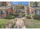 Multi-level condo building with balconies, brick accents, and a 'For Sale' sign indicating a listing opportunity at 13704 E Lehigh Ave # D, Aurora, CO 80014