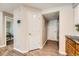 Hallway with stylish flooring, providing access to various rooms and featuring a convenient laundry closet at 13704 E Lehigh Ave # D, Aurora, CO 80014