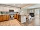 Modern kitchen with granite countertops, stainless steel appliances, and beautiful stone backsplash, open to living room at 13704 E Lehigh Ave # D, Aurora, CO 80014