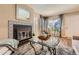Cozy living room featuring a fireplace, ample natural light, and hardwood flooring at 13704 E Lehigh Ave # D, Aurora, CO 80014