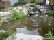 Scenic view of a beautiful pond with a waterfall surrounded by lush greenery and rocks at 13704 E Lehigh Ave # D, Aurora, CO 80014