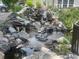 Charming water feature with stacked rocks, creating a peaceful and natural outdoor element at 13704 E Lehigh Ave # D, Aurora, CO 80014