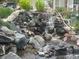 Picturesque water feature with stacked rocks, enhancing the outdoor living space and natural aesthetic at 13704 E Lehigh Ave # D, Aurora, CO 80014