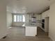 Bright kitchen featuring a large island, modern appliances, and sleek white cabinetry at 1261 Penner Dr, Erie, CO 80026