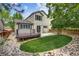 Charming backyard with a deck, a well-manicured lawn, and mature trees at 9737 Canberra Ct, Highlands Ranch, CO 80130