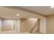 Spacious basement with carpet, stairs to the main floor, and a door to a bathroom at 9737 Canberra Ct, Highlands Ranch, CO 80130