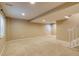 Spacious basement area with beige carpet, neutral walls, and a window for natural light at 9737 Canberra Ct, Highlands Ranch, CO 80130