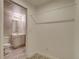 Bright bathroom featuring a modern vanity, updated floors, and a separate toilet area at 9737 Canberra Ct, Highlands Ranch, CO 80130