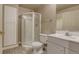 Modern bathroom featuring a glass shower, toilet, and vanity with white cabinets at 9737 Canberra Ct, Highlands Ranch, CO 80130