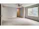 Spacious bedroom with a ceiling fan and large window at 9737 Canberra Ct, Highlands Ranch, CO 80130