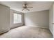 Bright bedroom with large window and neutral carpet at 9737 Canberra Ct, Highlands Ranch, CO 80130