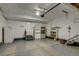 Spacious garage with storage shelves, lawn mower, and overhead door opener at 9737 Canberra Ct, Highlands Ranch, CO 80130