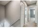 Hallway with neutral paint, carpet, and white doors at 9737 Canberra Ct, Highlands Ranch, CO 80130