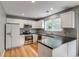 Modern kitchen with stainless steel appliances, white cabinets, and hardwood floors at 9737 Canberra Ct, Highlands Ranch, CO 80130