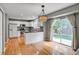 Bright open kitchen with stainless appliances, white cabinets, and access to a patio at 9737 Canberra Ct, Highlands Ranch, CO 80130