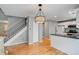 Open floor plan with hardwood floors, view of stairs and kitchen at 9737 Canberra Ct, Highlands Ranch, CO 80130