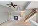 Inviting living room with a fireplace, open staircase, and a view into the next room at 9737 Canberra Ct, Highlands Ranch, CO 80130