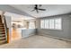 Spacious living room with stairs and large windows leads into a modern kitchen at 9737 Canberra Ct, Highlands Ranch, CO 80130