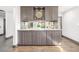 Stylish bar area with gray cabinets, mirrored backsplash, and marble countertop at 6490 E Dakota Ave, Denver, CO 80224
