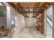 Unfinished basement with concrete walls, exposed ceiling, utility connections and access to upper level at 6490 E Dakota Ave, Denver, CO 80224