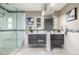 Elegant bathroom featuring double vanity sinks, a glass-enclosed shower, and modern fixtures at 6490 E Dakota Ave, Denver, CO 80224
