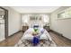 Cozy bedroom with neutral decor, hardwood floors, and window with natural light at 6490 E Dakota Ave, Denver, CO 80224