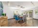 Bright dining room with hardwood floors, chandelier lighting, and glass sliding door at 6490 E Dakota Ave, Denver, CO 80224
