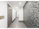 Modern entryway with tile feature wall and wood door at 6490 E Dakota Ave, Denver, CO 80224