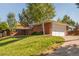 Charming single-story brick home with well-manicured landscaping and a two-car garage at 6490 E Dakota Ave, Denver, CO 80224
