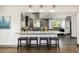 Open-concept kitchen with granite countertops, modern appliances, and a breakfast bar at 6490 E Dakota Ave, Denver, CO 80224