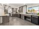 Contemporary kitchen featuring gray cabinetry, stainless steel appliances, and peninsula seating at 6490 E Dakota Ave, Denver, CO 80224