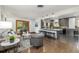 Bright and airy living area with an open floor plan that leads into the modern kitchen at 6490 E Dakota Ave, Denver, CO 80224