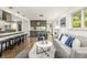 Cozy living room featuring a wet bar, neutral decor, and ample natural light at 6490 E Dakota Ave, Denver, CO 80224