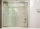 Basement shower with glass enclosure and built-in shelving at 6490 E Dakota Ave, Denver, CO 80224
