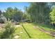 Picturesque backyard showcasing lush greenery, a stone patio, comfortable seating, and mature trees at 6248 W 75Th, Arvada, CO 80003