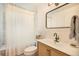 Updated bathroom with a shower, toilet, vanity, and modern fixtures at 6248 W 75Th, Arvada, CO 80003
