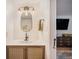 Modern bathroom vanity featuring a sink, stylish fixtures, and a decorative mirror at 6248 W 75Th, Arvada, CO 80003