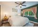 Comfortable bedroom with a ceiling fan, a large bed, and natural lighting at 6248 W 75Th, Arvada, CO 80003