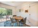 Cozy dining area with backyard patio access, table with three chairs and nature themed wall art at 6248 W 75Th, Arvada, CO 80003