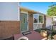 Close up on the front entrance, showcasing a brick facade, beautiful door, and landscaped surroundings at 6248 W 75Th, Arvada, CO 80003
