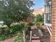Beautifully landscaped front yard with a brick pathway, colorful flowers, and mature trees adding to the curb appeal at 6248 W 75Th, Arvada, CO 80003