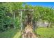A beautiful garden gate and arbor covered in lush greenery, leading to a serene backyard space at 6248 W 75Th, Arvada, CO 80003